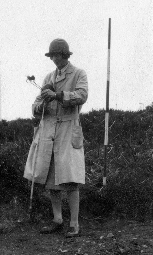 Dorothy Liddell with tape, surveyors arrows and an imperial ranging pole