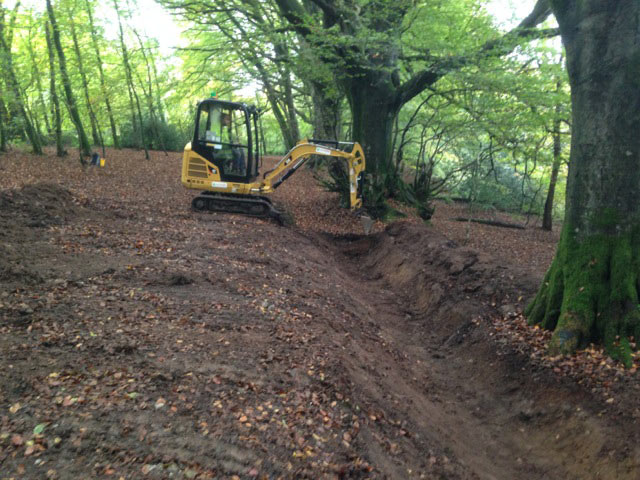 DCC archaeologist working with the digger man sorting the parish boundary ditch out